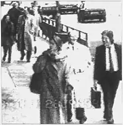 Black and white CCTV frame showing Taylor and Hayes outside Harrods