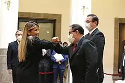 Vásquez elbow bumps Áñez shortly after being sworn in.