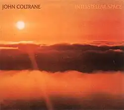 An orange photo of the sun above the clouds with "JOHN COLTRANE" written in brown and "INTERSTELLAR SPACE" written in orange at the top.