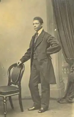 Martin standing next to a chair