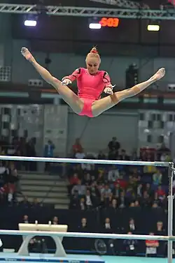 Jonna Adlerteg performing a release move on the uneven bars
