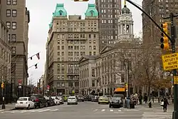 Temple Bar Building, a high-rise clad in brown brick, viewed in the background from an adjacent street