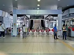 Fare gates at the LRT station concourse level.