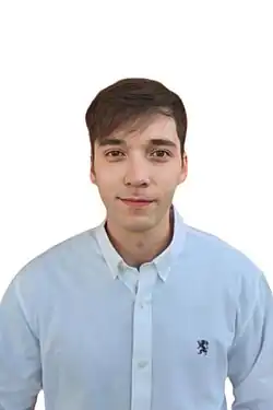 Stefan William wearing a white shirt, looking directly at camera with slight smile