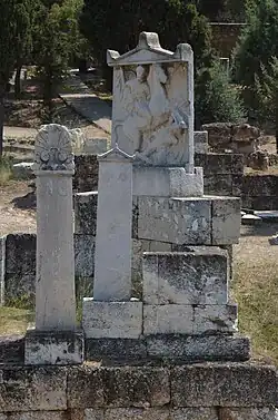Marble tombstones, including one showing a figure on horseback spearing a defeated enemy.