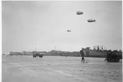 LST-60 and USS&nbsp;LST-30 along with two unidentified LSTs beached at Normandy, after 6 June 1944