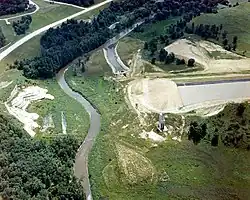 An aerial view of the incomplete Kickapoo River Dam, with the river in the center