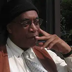 Photo of Larry Pinkney with his pointer finger resting on his cheek in deep thought.