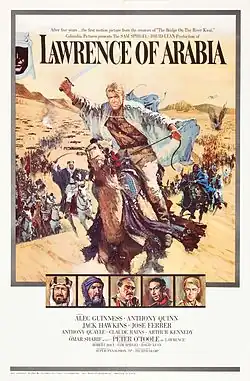 A painting occupies about 3/4 of the frame. A man riding a galloping horse across sand is the most prominent image. The man is holding a raised scimitar in his right hand; he is wearing a white robe, suggestive of Arabian clothing, but looks to be European with blond hair. Behind him are many more mounted men charging with raised swords, extending far into the background and a sandy hill. At the top of the painting, which shows the sky above the hill, the words "Lawrence of Arabia" are written using a large, formal font suggestive of printing. Two lines of small lettering above these words have the phrases "After five years .... the first motion picture from the creators of 'The Bridge on the River Kwai'" and "'Columbia Pictures presents the SAM SPIEGEL - DAVID LEAN production of'". Beneath the main painting are a row of five small painted portraits of five men wearing Arabian and European dress; one is the same man leading the charge in the main painting. Beneath these paintings is the billing block of the poster: "starring Alec Guinness - Anthony Quinn / Jack Hawkins - Jose Ferrer / Anthony Quinn - Claude Rains - Arthur Kennedy / with Omar Shariff as 'Ali' - introducing Peter O'Toole as 'Lawrence' / screenplay by Robert Bolt - produced by Sam Speigel - directed by David Lean / Photographed in Super Panavision 70 - a horizon picture in Technicolor".