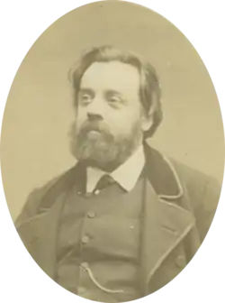 Portrait photograph of Gustave Lefrançais, wearing a beard and a neat suit