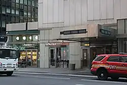 The main entrance on Lexington Avenue, which consists of a set of metal doors on either side of a revolving door