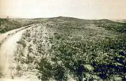 Photo taken in 1894 by H.R. Locke on Battle Ridge looking toward Last Stand Hill (top center). To the right of Custer Hill is Wooden Leg Hill, named for a surviving warrior. He described the death of a Sioux sharpshooter killed after being seen too often by the enemy.[237][238]