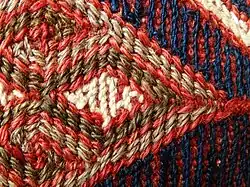 Detail of weft wrapping: "weft yarns .. can be pushed about as the weaver wishes"[4]