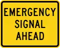 W11-12P Emergency signal ahead (plaque)