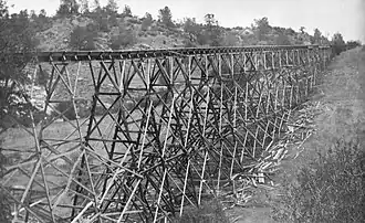 A tall V-flume trestle around 1900.