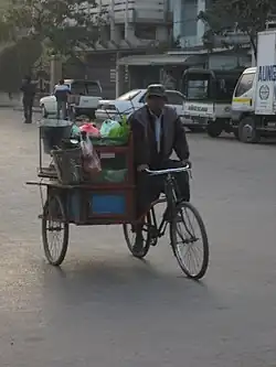 A mohinga trishaw peddler in Mandalay will stop for customers.