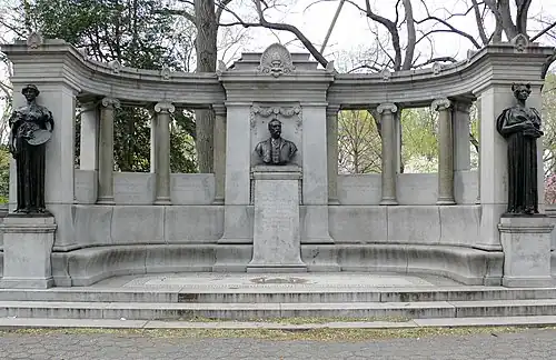Three bronze statues on the left, center, and right of a larger curved stone structure