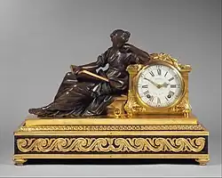 Neoclassical mantel clock (pendule de cheminée); 1757–1760; gilded (ormolu) and patinated bronze, oak veneered with ebony, white enamel with black numerals, and other materials; 48.3 × 69.9 × 27.9&nbsp;cm; Metropolitan Museum of Art