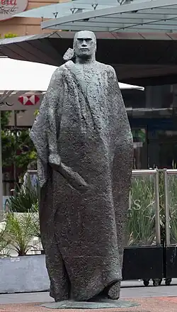 A Maori Figure in a Kaitaka Cloak, by Molly Macalister, bronze, 1967. It is located at Quay St across the street from the Ferry Building