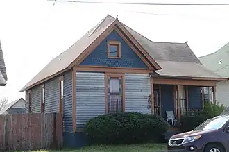 Old and new: house with car in Marshall Square Historic District