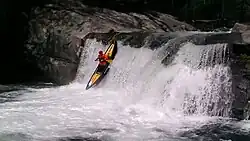 A whitewater canoe with yellow air bags.