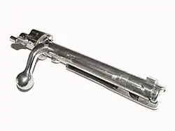 A Mauser 98 bolt showing two locking lugs just behind the face of the bolt. There is a third "emergency" lug in front of the bolt handle, in case the primary ones fail under pressure. In some designs the bolt handle itself may serve as the emergency "lug".