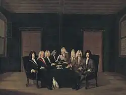 A painting showing eight bewigged men, sat around a table with papers and quills.