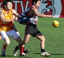 Japan Samurai captain Michito Sakaki being tackled by a Vietnamese opponent in 2006
