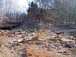 The remains of the 18th-19th century cut across the peninsula of the Jug, as viewed in 2006. The creek is partially prevented from flowing here by the dam effect of the low water bridge visible at left (see photograph below); the creek is slightly visible at right, having emerged from a 3.3 mile (5.3 km) meander.