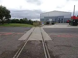 Site of the first timber-built station, opened in 1830 by the Stockton & Darlington Railway, now an industrial estate.