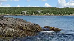 View of rocks and land across the bay