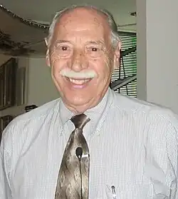 Picture of an elderly man with a mustache and smile