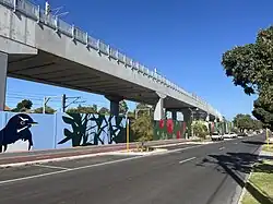 A tall concrete viaduct viewed from the street