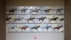 The station is decorated with jockeys on horses.