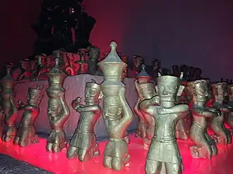 Bronze figurines wearing belted tunics, Sanxingdui