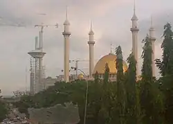 Abuja National Mosque with golden dome and four minarets.