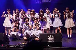 Members of Nogizaka46 performing on stage