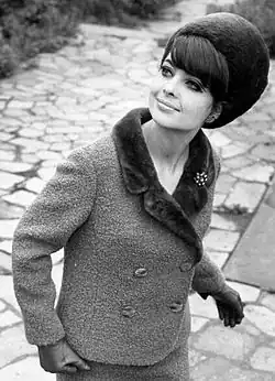Fashion model from Leipzig, GDR, wearing a wool suit trimmed with fur and a matching fur hat, 1966
