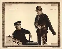 A 1921 lobby card depicting a scene from the film; William S. Hart's character tells Bert Sprotte's character, "I'm going to resign from the service -- I can't arrest the brother of the woman I love."