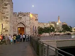 An archway and gate in a large stone wall