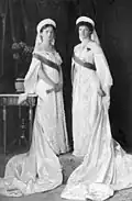 Grand Duchess Olga Nikolaevna and Grand Duchess Tatiana Nikolaevna wearing court dress including sashes, kokoshnik, and veils, 1913.