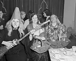 Black and white image of people dancing, in various hallowe’en costumes.