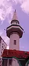 The pencil-like minaret of the mosque which has influence from Ottoman styles.