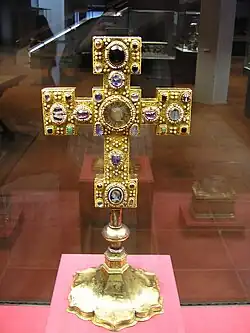 Golden cross on a pedestal with inlayed gems