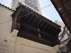 The wooden canopy above the street entrance