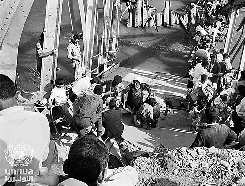 Palestine refugees flee across the Allenby Bridge during the second Arab-Israeli hostilities in 1967