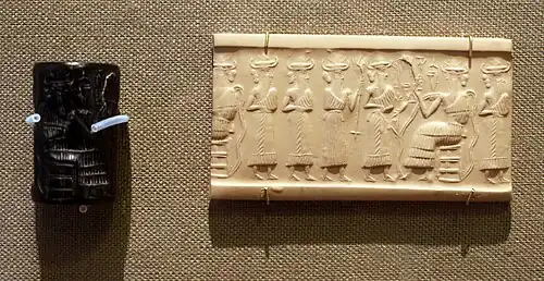 Akkadian cylinder seal depicting four deities stepping before the enthroned Enki.