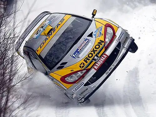 Image 2Juuso Pykälistö in his Peugeot 206 WRC during the 2003 Swedish Rally. Peugeot is a major French car brand, part of the PSA Peugeot Citroën group.