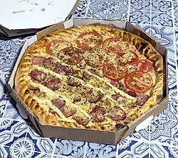 Half calabresa com catupiry, half napolitana (tomatoes with parmesan) pizza with a stuffed soft crust