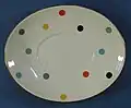 A plate patterned with multicoloured polka dots